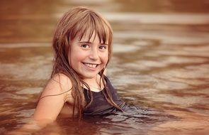 girl with red hair bathes in a lake