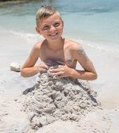 portrait of boy in the sand on the beach