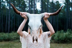 girl holding skull horns