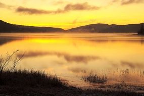 colorful orange sunset reflected in the lake