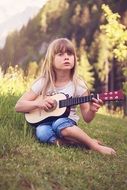 girl playing guitar in the woods