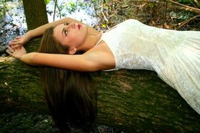 girl in a white dress on a background of forest nature