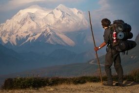 landscape of snow mountains and hiker