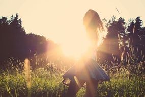 Sunset On The Brunette Girl On The Grass