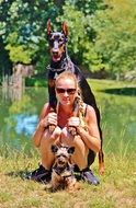 woman with a Doberman in nature