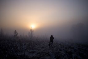 man in the morning sunny haze in winter