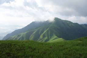 clouds on green wugongshan mountains