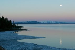 sunset moon over yellowstone lake