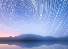 star trails above a lake