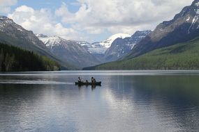 landscape of boatmen on lake in glacier national park