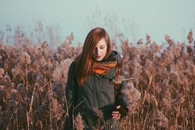 young woman in the field of tall plants