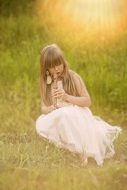 flute girl plays on a straw in nature