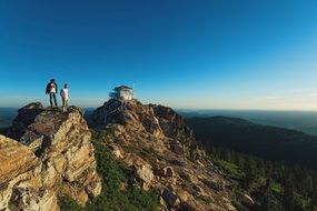 Men on top mountains cliffs hills