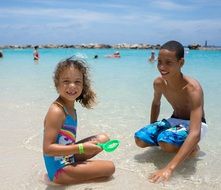 girl and boy on the beach in summer