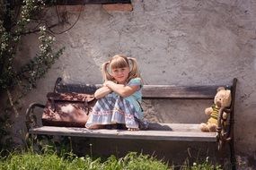 blond girl sitting on the bench