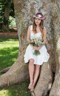 teen girl with flowers near a big tree