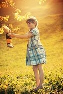 girl playing with teddy bear outdoor