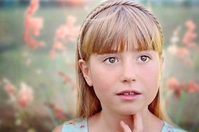 portrait of a beautiful blonde girl with the flowers on background