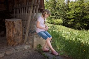 nice girl sitting out on wood