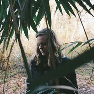 woman behind a tree branch