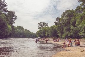 people relaxing by the lake