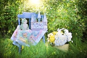 child castle on table in green grass daisies