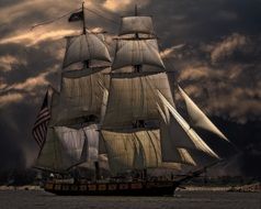 sailing ship on water at dusk