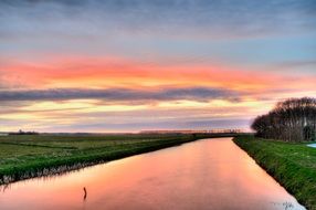 Pink sunset reflection on a river