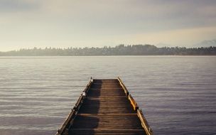 wooden pier on a lake with calm water