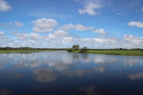 landscape with clouds, mirroring in still water, australia