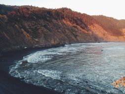 brown mountains on the ocean