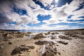 cumulus clouds over rocky coast