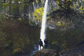 mountain hikers at waterfall