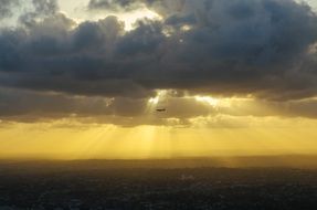 airplane in the sunlight through the clouds