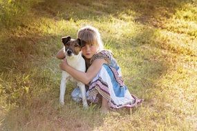 girl with a puppy in the autumn field