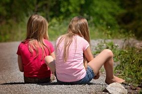 two girl blonde sitting on road