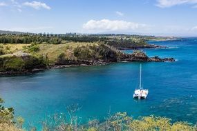 beautiful coastline with catamaran on water