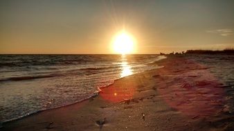 tropical beach sunset with golden reflection