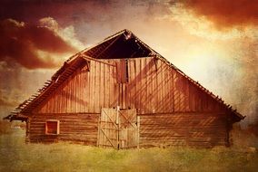 wooden barn among the meadow in the sunlight