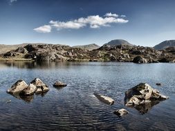 Stones in the lake near the mountains