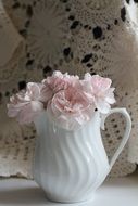 Beautiful pink and white flowers in a white jar