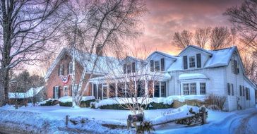 house in snowy weather at sunset