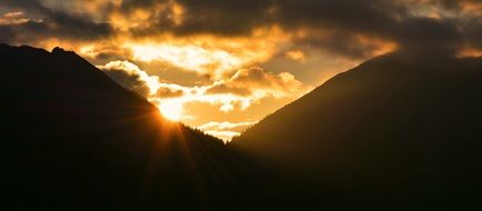 fiery sun nd mountains at sunrise