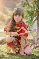 sitting blonde girl in indian clothes