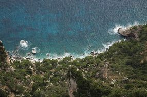 green mountain side at sea