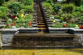 garden waterfall on stairs with flowers