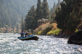 Athletes on a boat on a river in a canyon of a bear, Montana