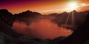 golden sunset over a mountain lake as a phantasia