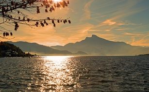 beautiful sun setting over water in austria