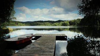 rowing boat at the pier of the river